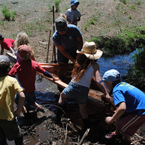 Ranch campers setting a tarp